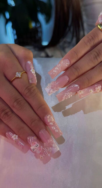 Long pink Gel X set with 3D flowers, pearls and charms